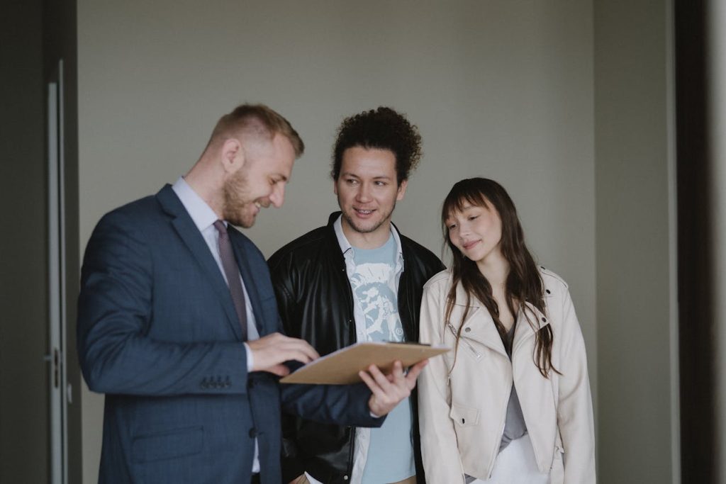 a couple going over the paperwork for their new home with a real estate agent
