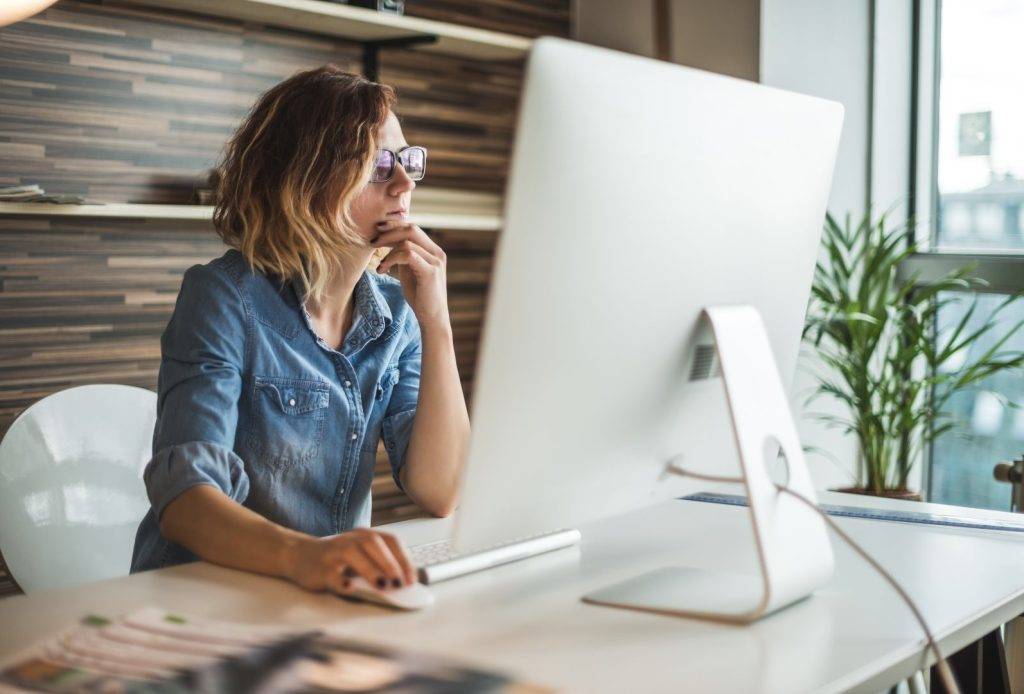 A woman working at her office - Rise Transactions